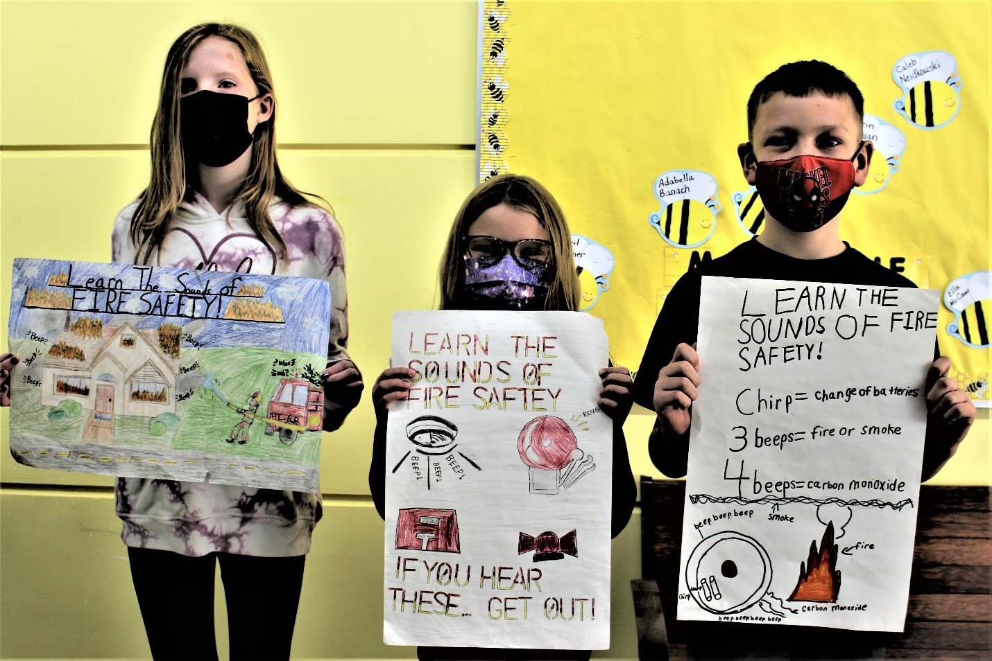 Hailey Gochenour, Sydney Moscatiello and Nathan Kinne display their award-winning posters.